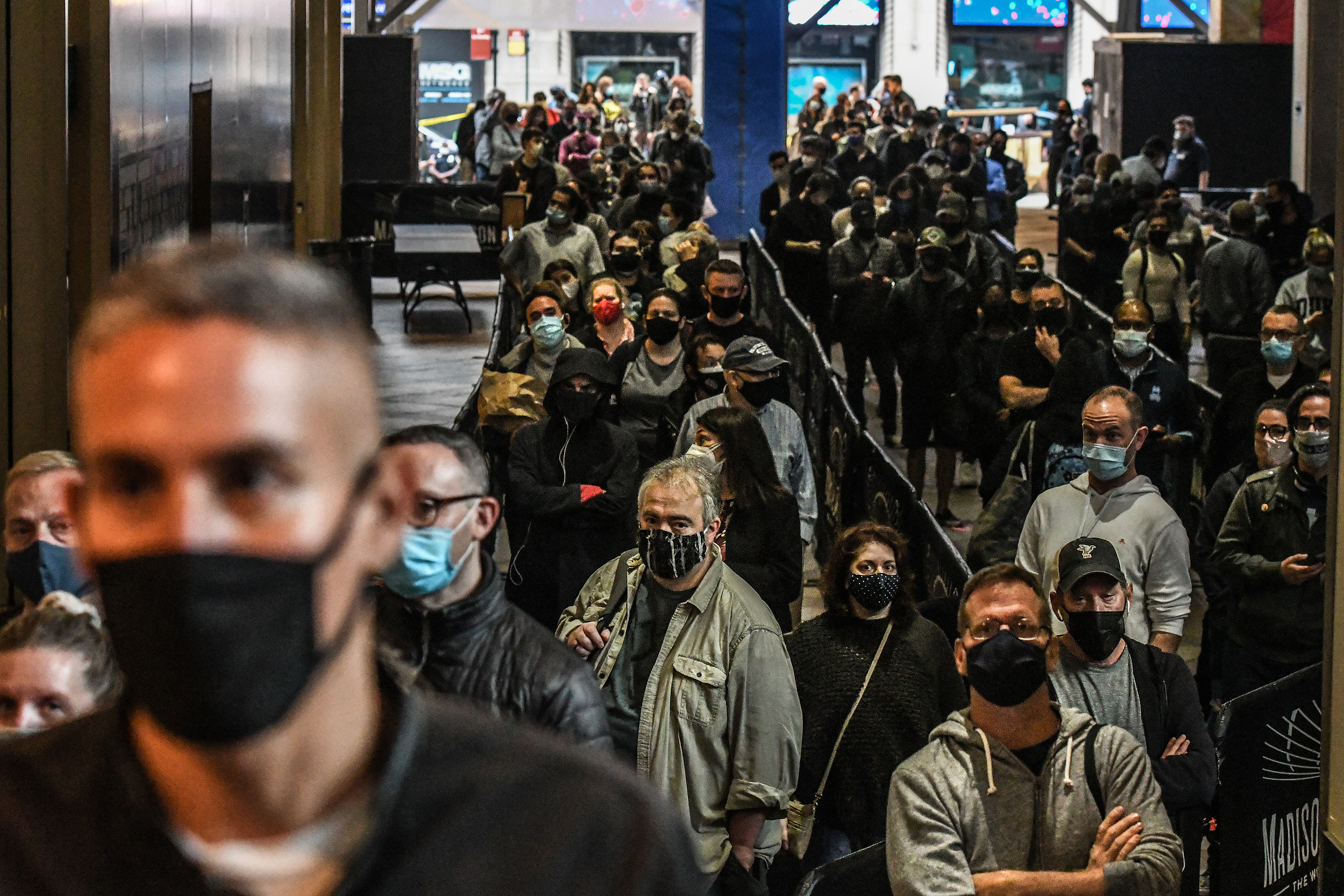 NEW YORK, NY - OCTOBER 24: People wait in a line to vote at Madison Square Garden during early voting for the U.S. Presidential election on October 24, 2020 in New York City. Due to the coronavirus and social distancing concerns New York State is allowing
